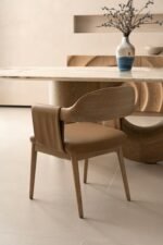 Designer dining chair with sculpted wood back