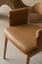 Designer dining chair with sculpted wood back